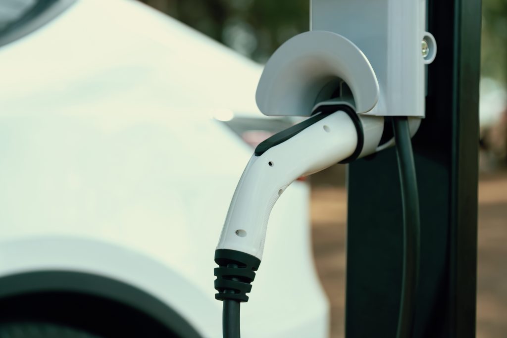 Closeup EV charger handle plugged in or connect to electric car. Perpetual