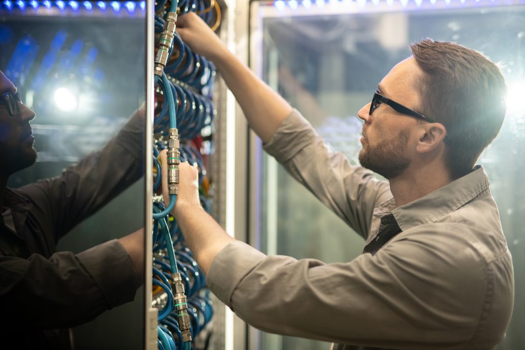 Data center engineer examining cables