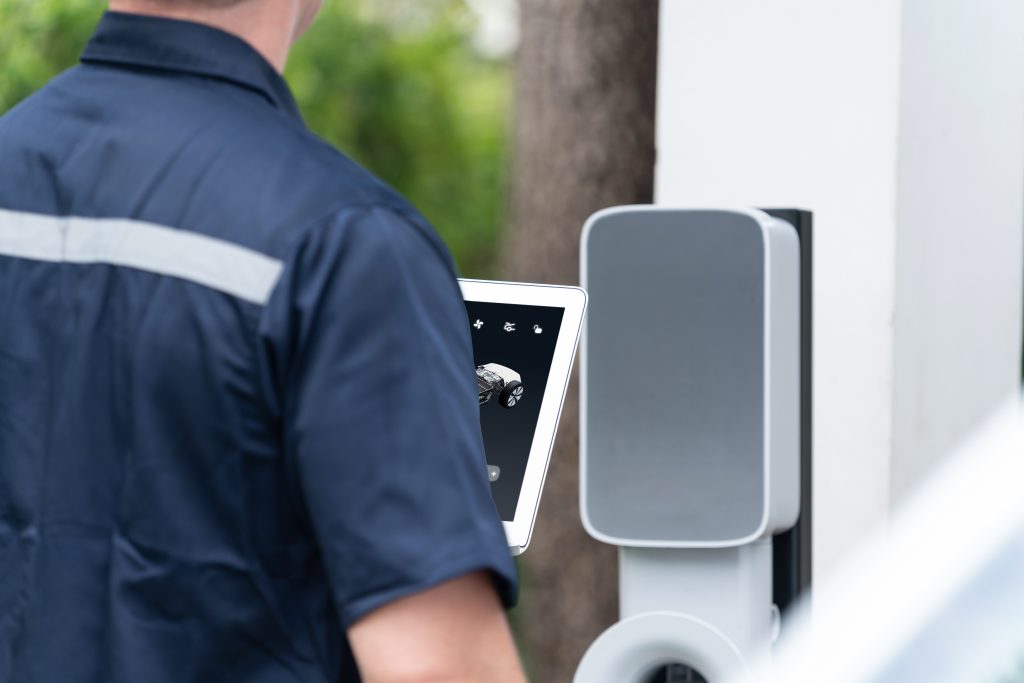 Qualified technician install home EV charging station. Synchronos